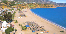 Nerja beach with fishing boats and umbrellas